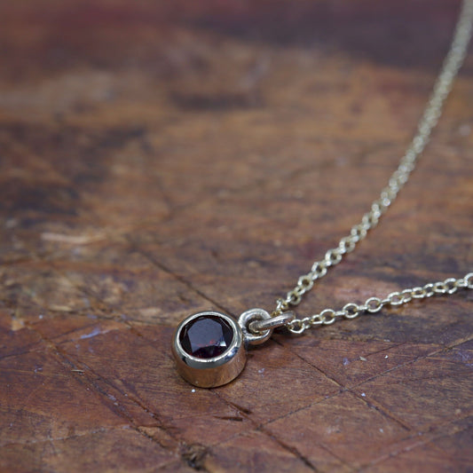 Yellow gold Garnet pendant with chain. January Birthstone