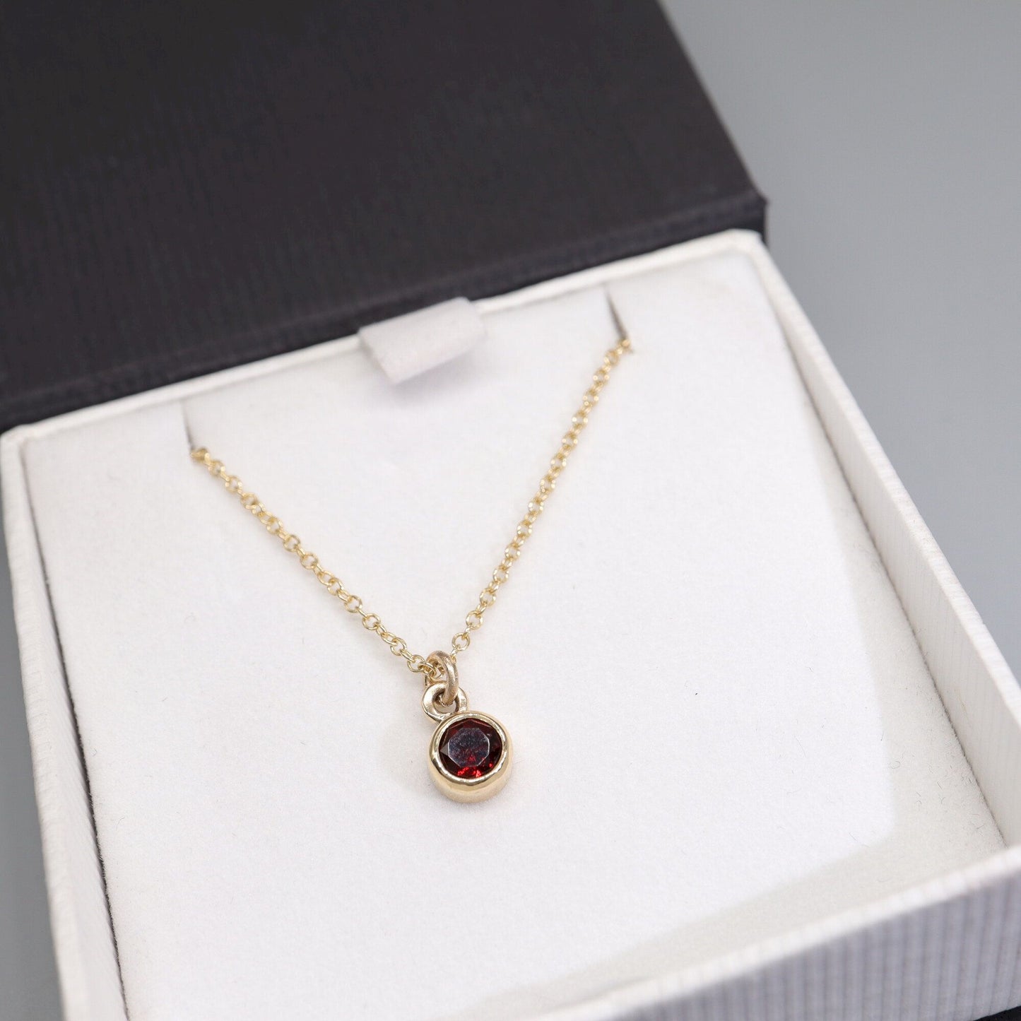 Yellow gold Garnet pendant with chain. January Birthstone