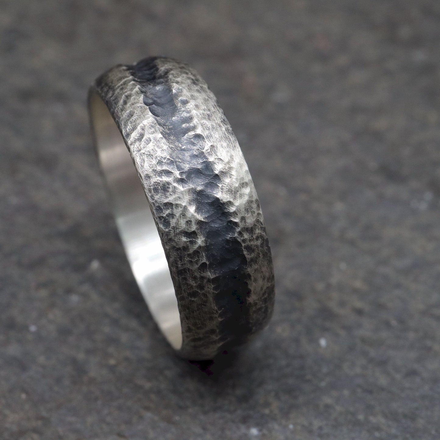 Black silver mans promise, engagement or wedding ring with a carved rustic pattern, Fleetwith Pike design.