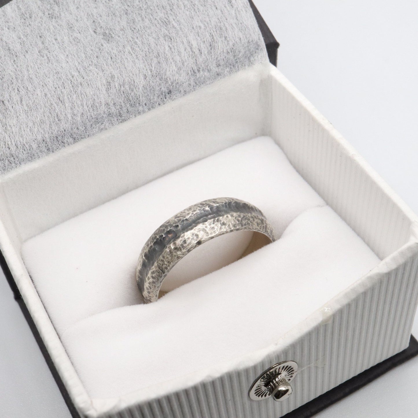 Black silver mans promise, engagement or wedding ring with a carved rustic pattern, Fleetwith Pike design.