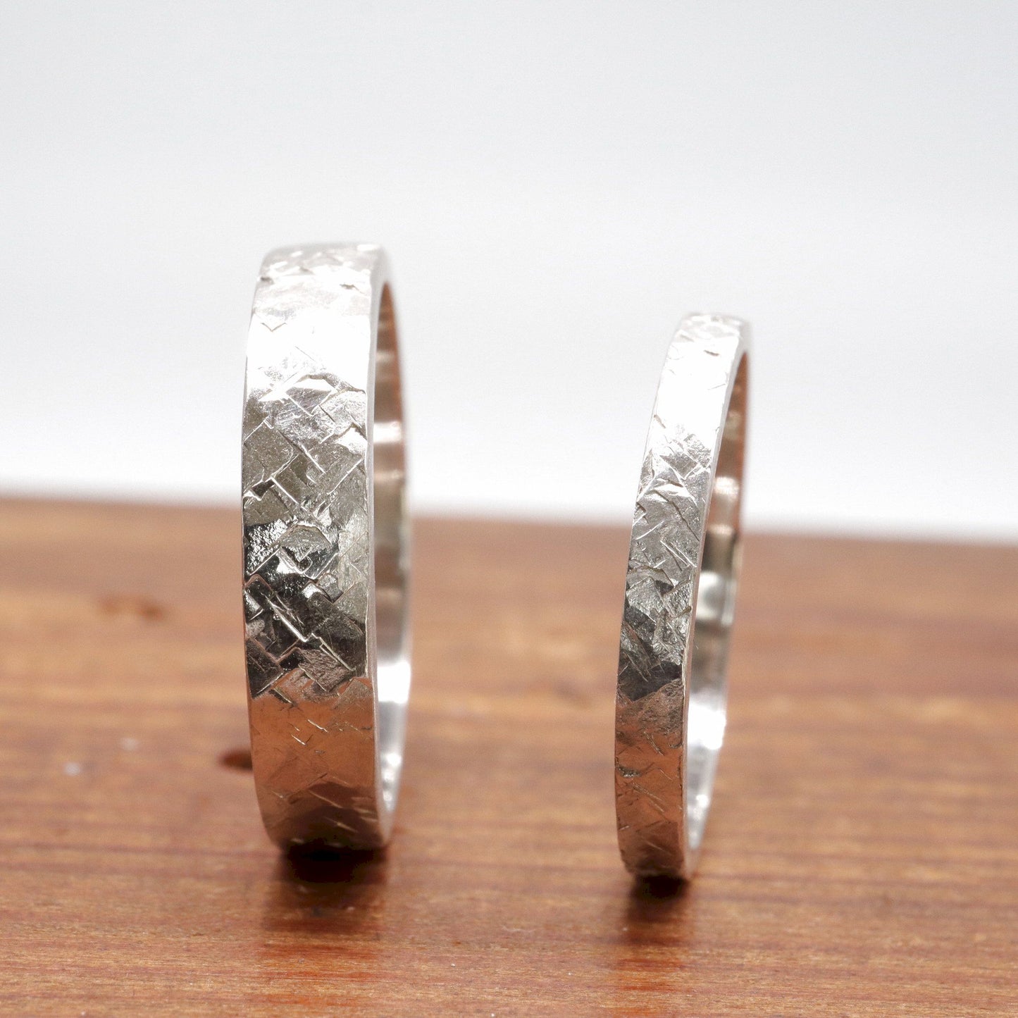 Matching Kendal Rustic Hammered 2mm and 4mm wedding ring set - flat textured white gold men and womens design.