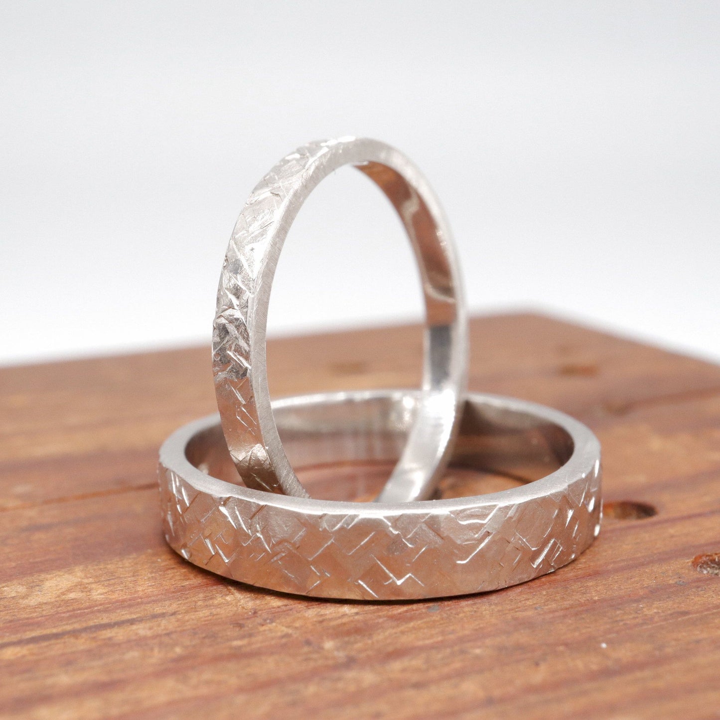 Matching Kendal Rustic Hammered 2mm and 4mm wedding ring set - flat textured white gold men and womens design.