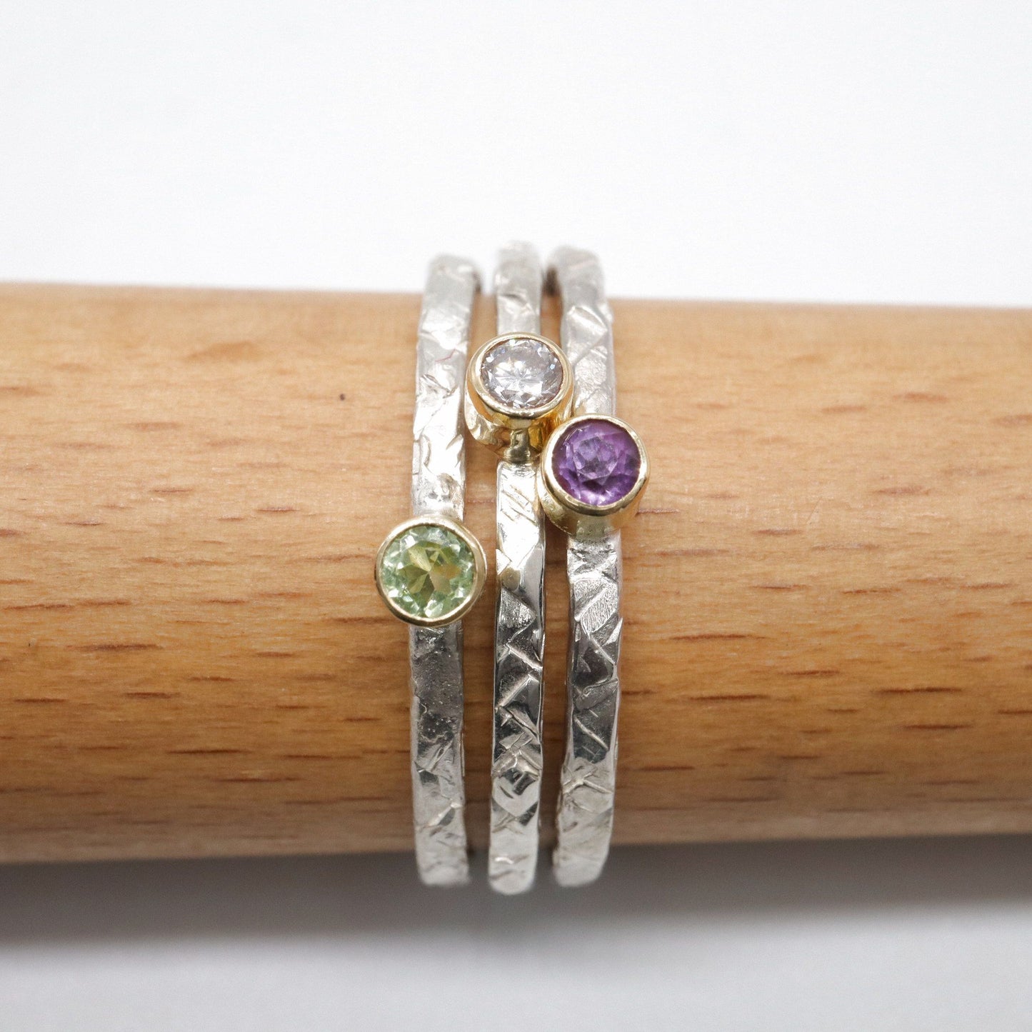 Stacking ring set of three with amethyst, diamond and peridot, Striding Edge design in 18ct yellow gold and silver.