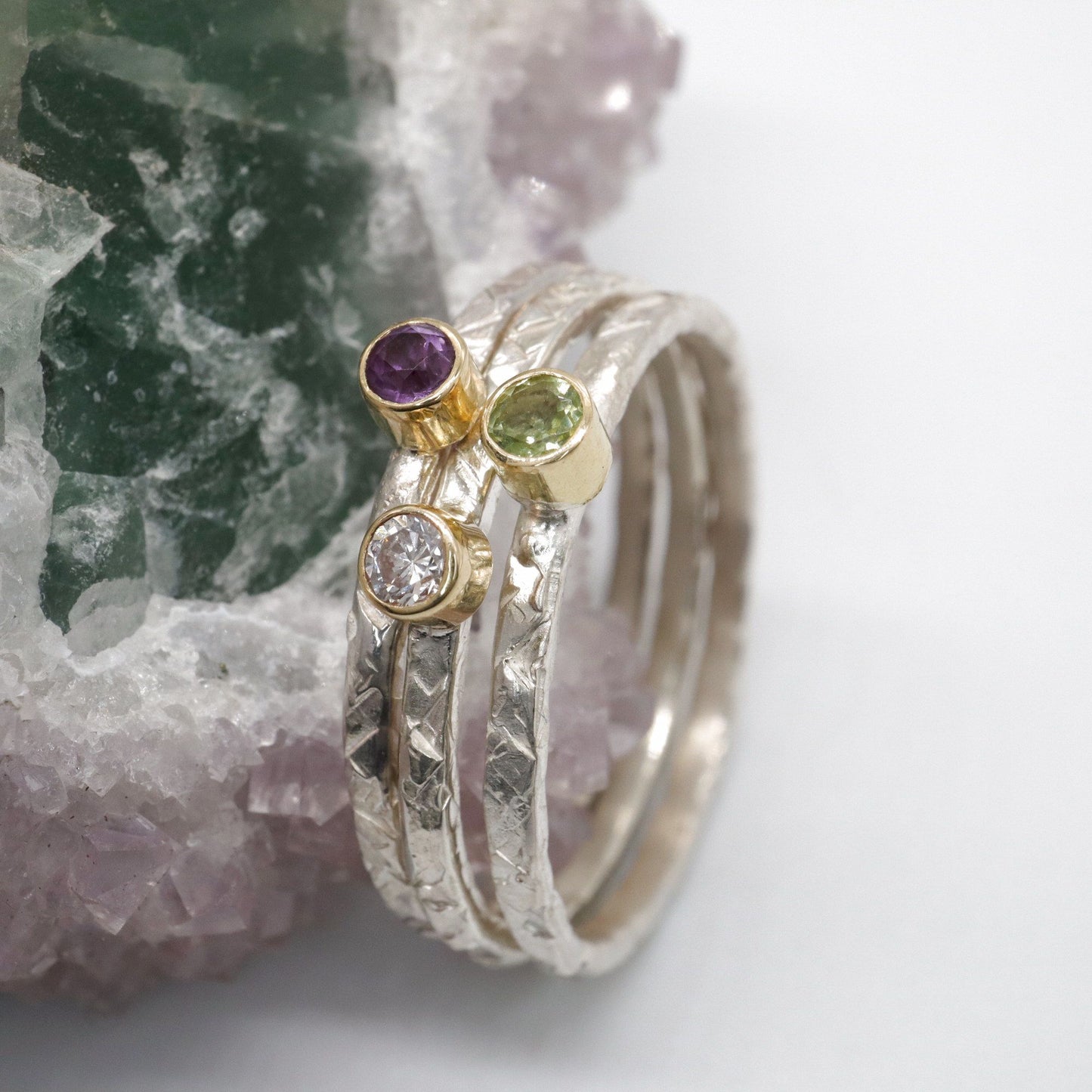 Stacking ring set of three with amethyst, diamond and peridot, Striding Edge design in 18ct yellow gold and silver.