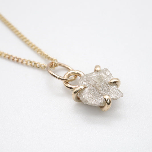 Diamond gold pendant set with one raw uncut natural diamond