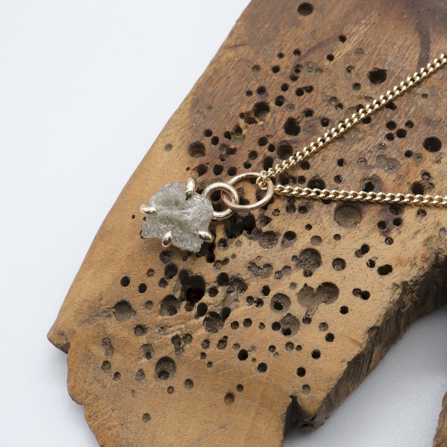 Diamond gold pendant set with one raw uncut natural diamond