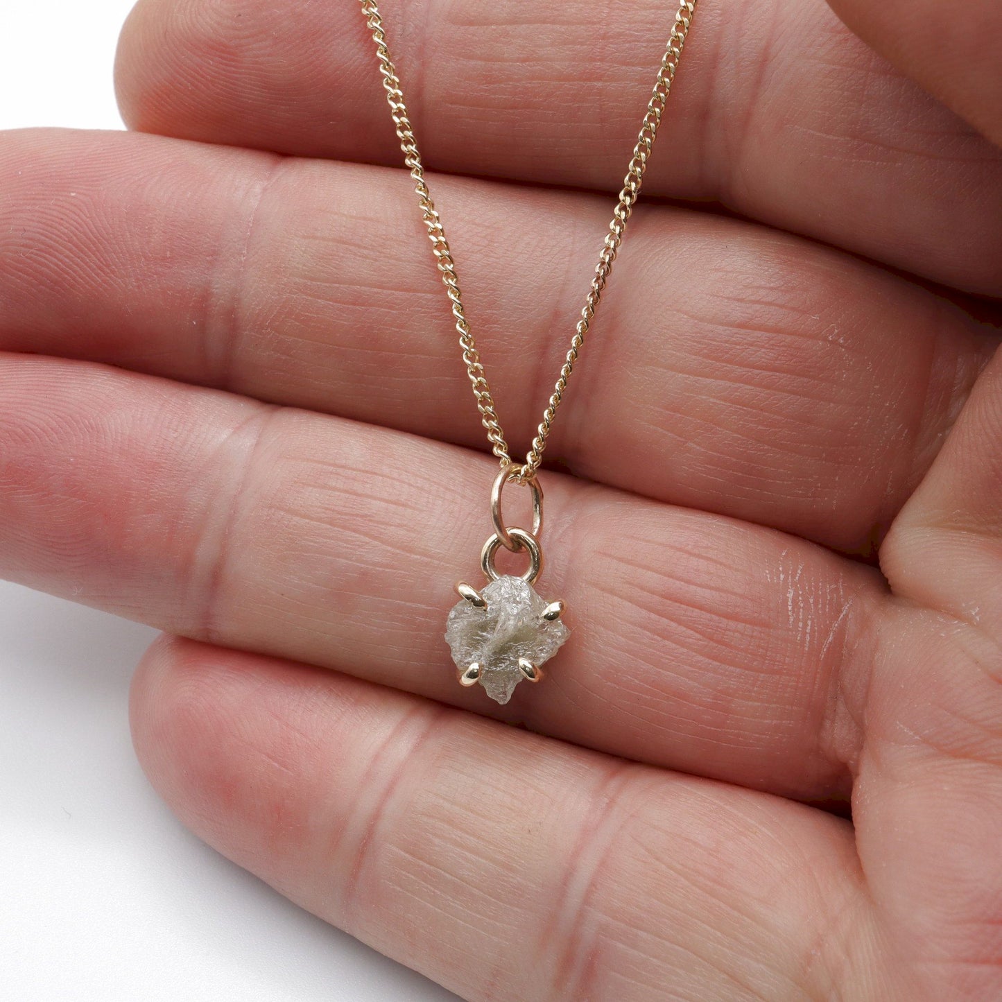 Diamond gold pendant set with one raw uncut natural diamond