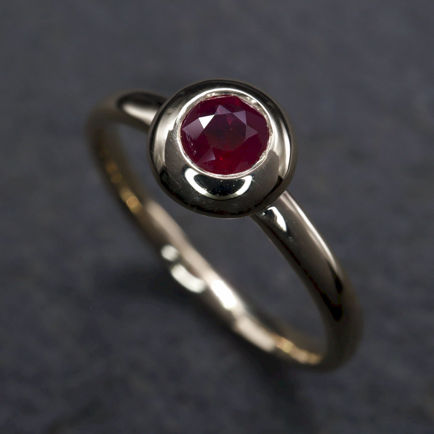 Solitaire fine Ruby engagement ring in yellow gold.