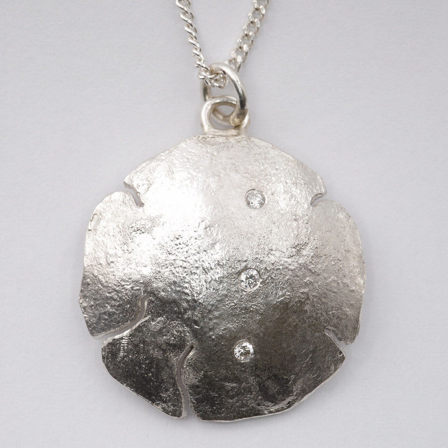 Diamond silver pendant, three stone design