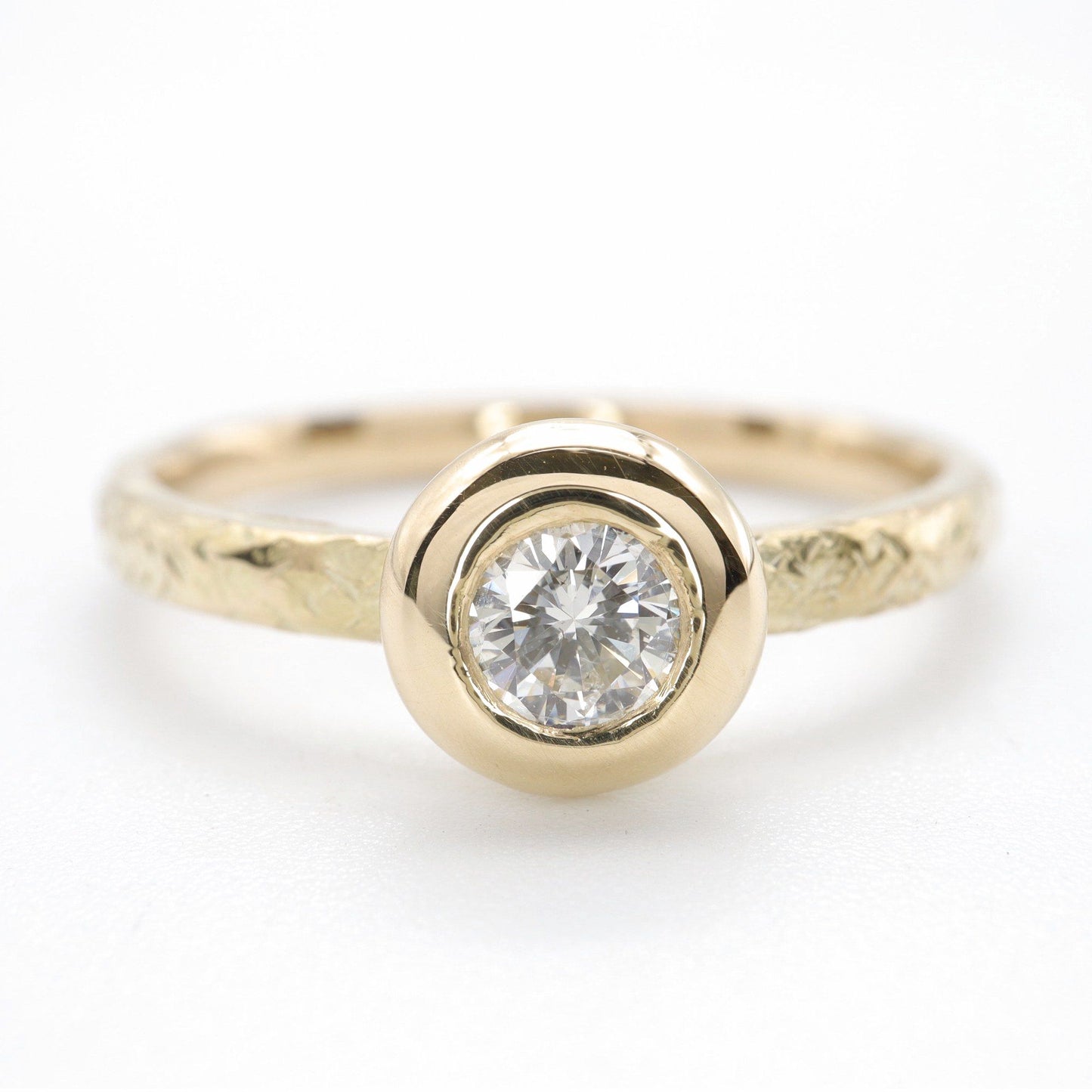 Solitaire diamond ring in 18ct yellow gold with a wide edge setting