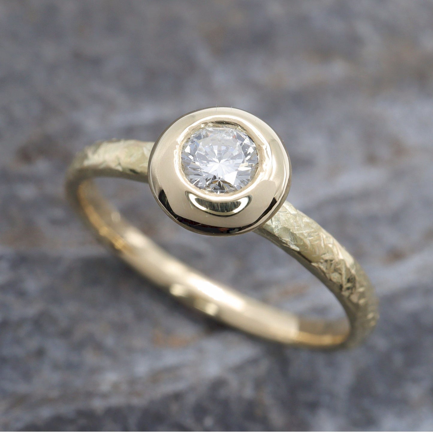 Solitaire diamond ring in 18ct yellow gold with a wide edge setting