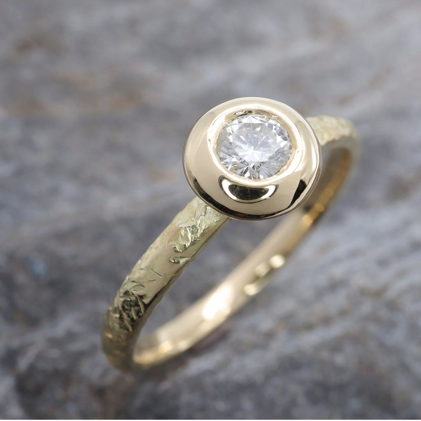 Solitaire diamond ring in 18ct yellow gold with a wide edge setting