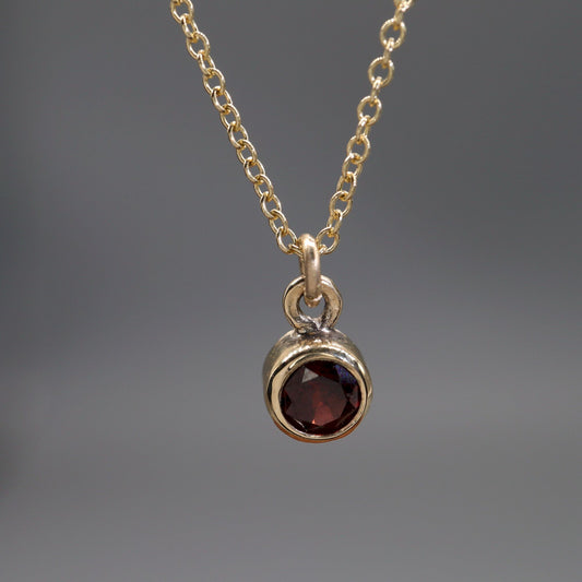 Yellow gold Garnet pendant with chain. January Birthstone