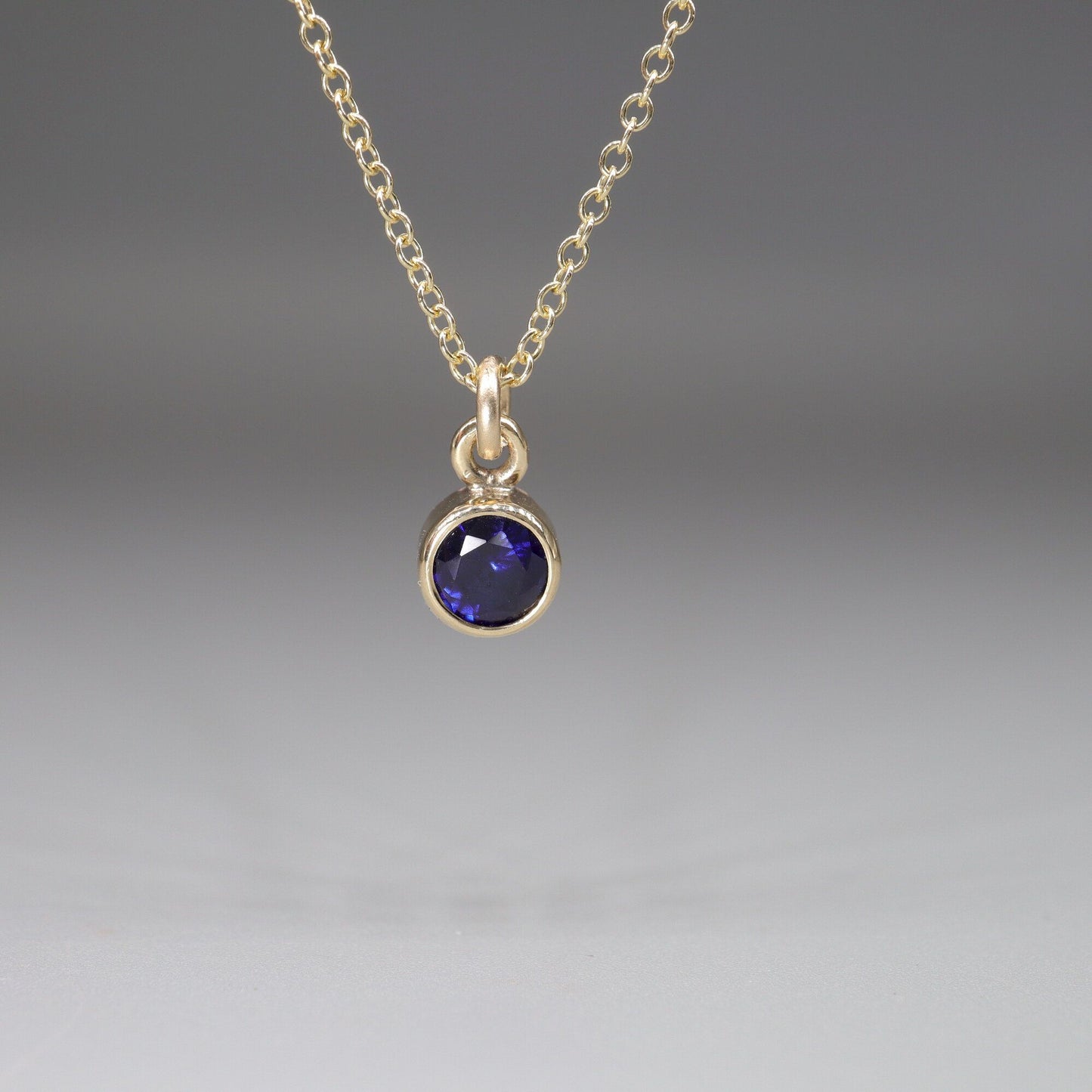Sapphire gold pendant with chain. Birthstone for September.