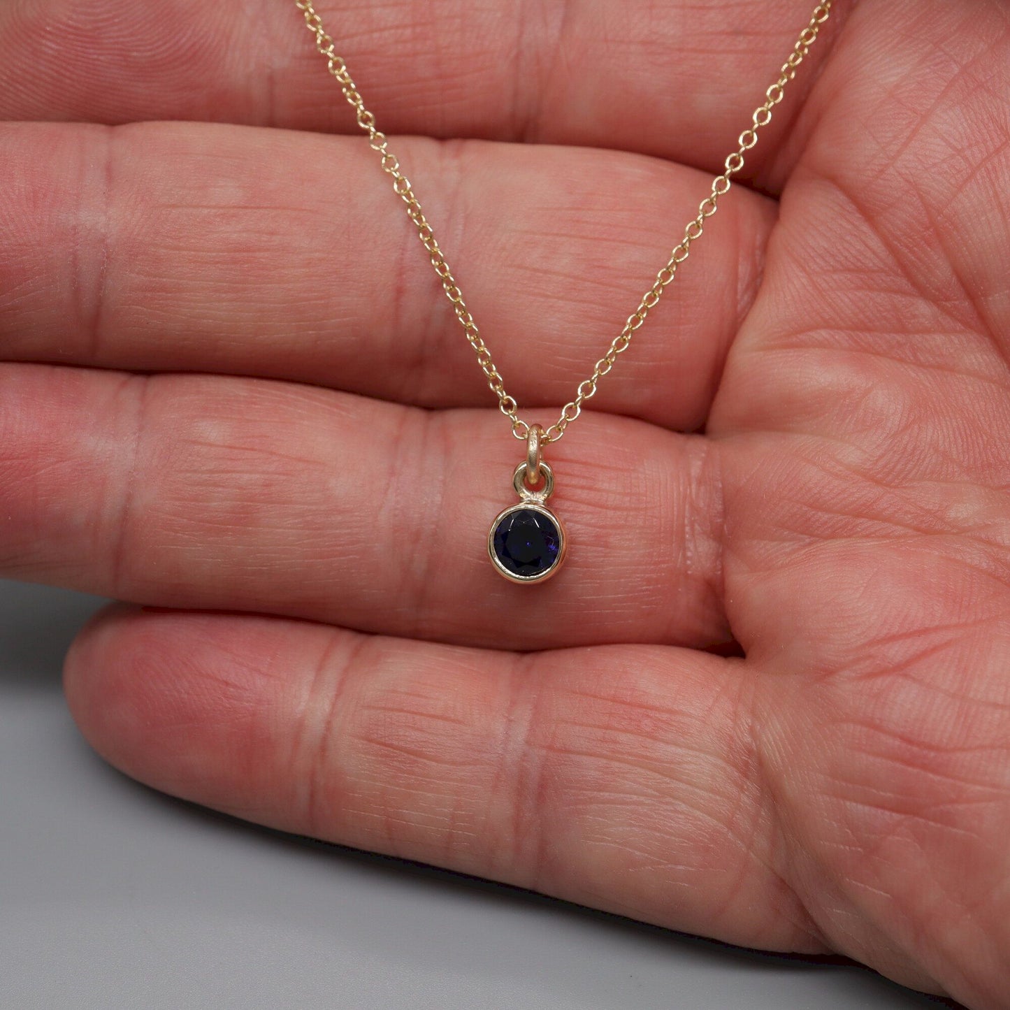 Sapphire gold pendant with chain. Birthstone for September.