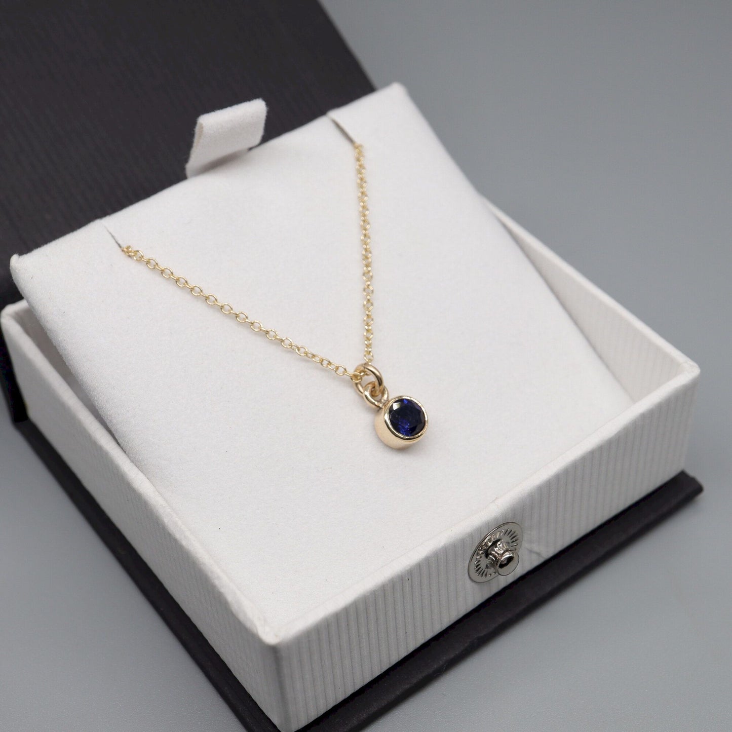 Sapphire gold pendant with chain. Birthstone for September.
