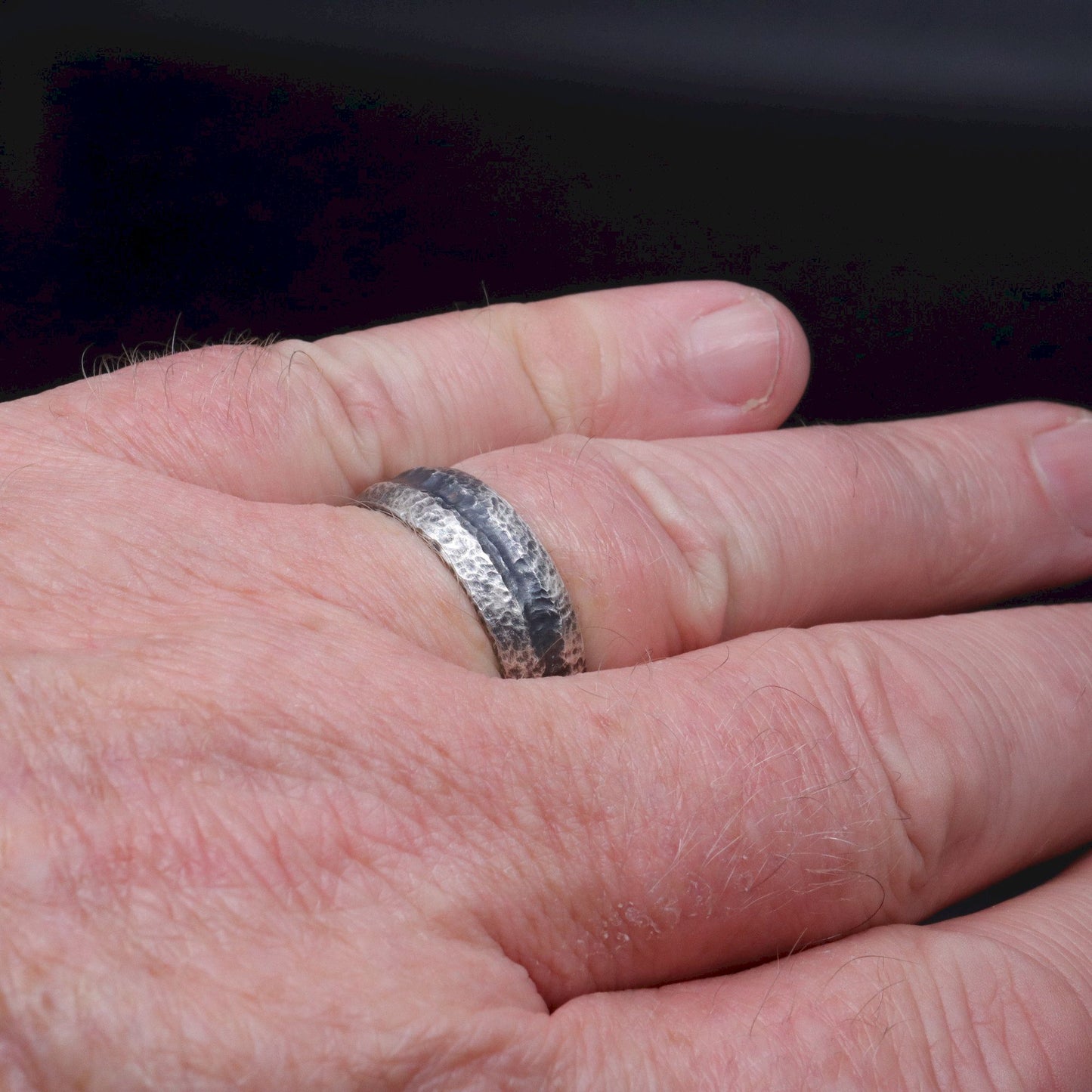 Black silver mans promise, engagement  or wedding ring with a carved rustic pattern, Fleetwith Pike design.