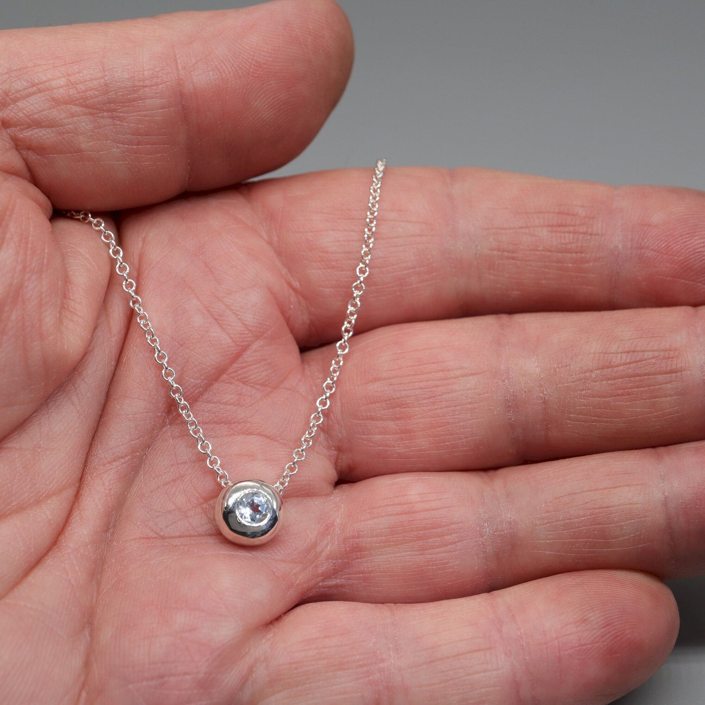 Blue Topaz runner pendant, silver slider button design, December Birthstone