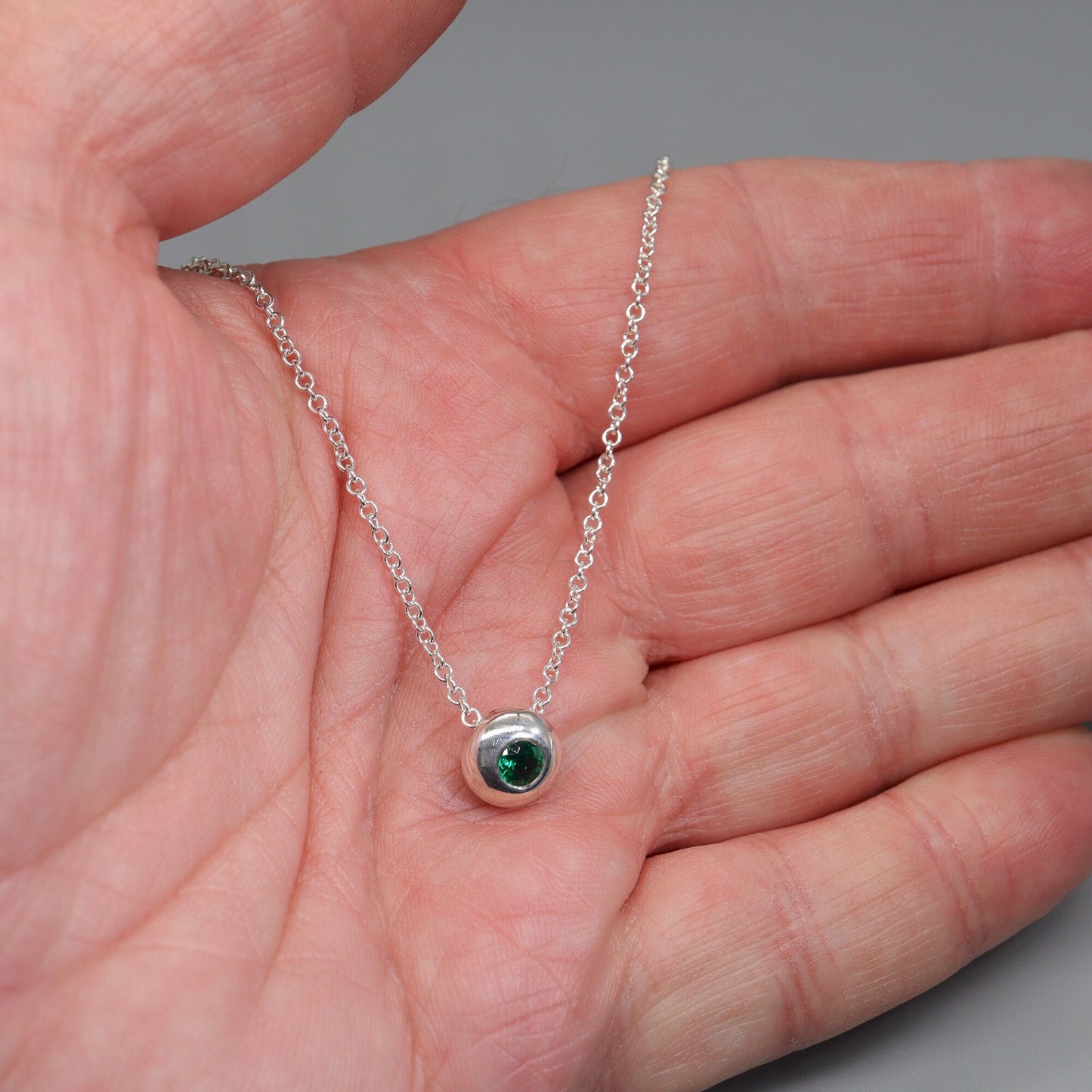 Emerald runner pendant, silver slider button design, May Birthstone