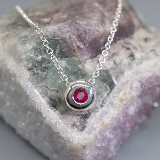 Ruby runner pendant, silver slider button design, July Birthstone