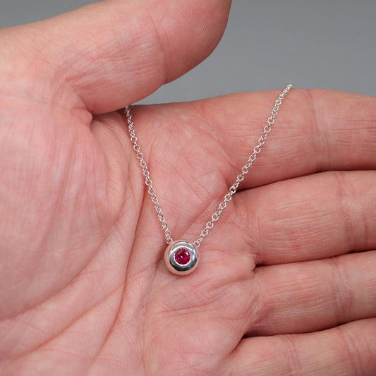 Ruby runner pendant, silver slider button design, July Birthstone