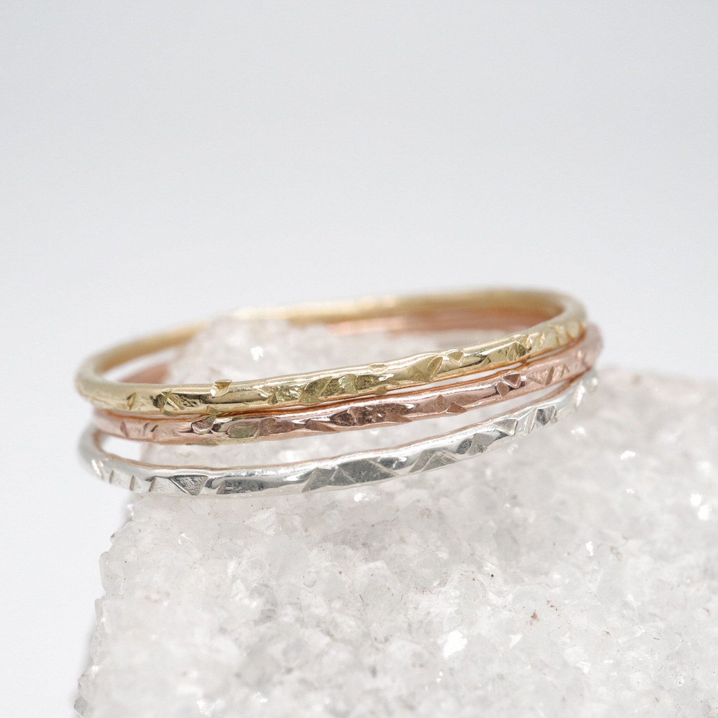 Stacking minimalist three ring set, Striding Edge hammered design in silver, 18ct yellow and 9ct rose gold.