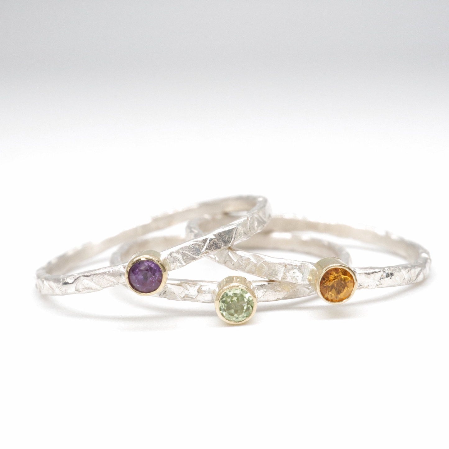Stacking ring set of three with peridot, amethyst and citrine, Striding Edge design in 18ct yellow gold and silver.