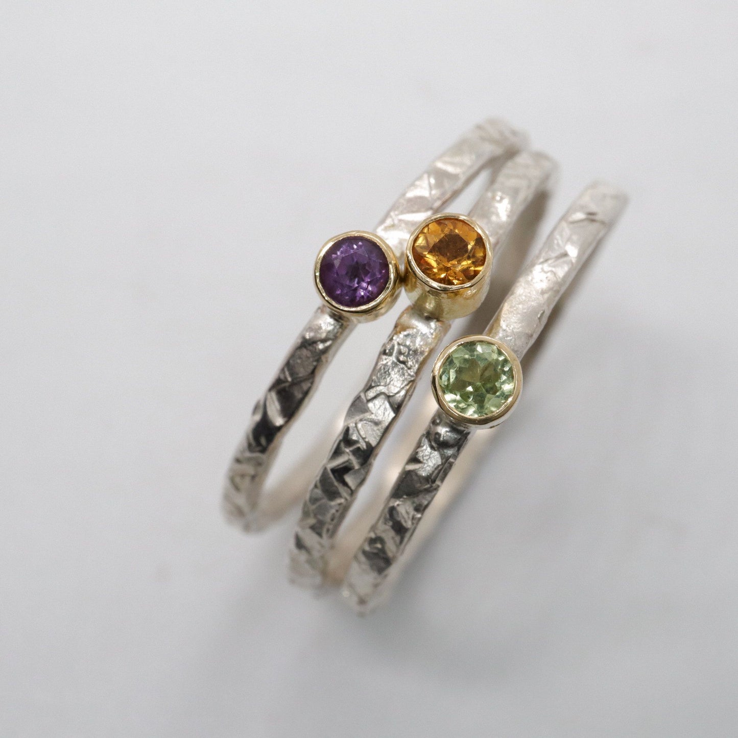 Stacking ring set of three with peridot, amethyst and citrine, Striding Edge design in 18ct yellow gold and silver.