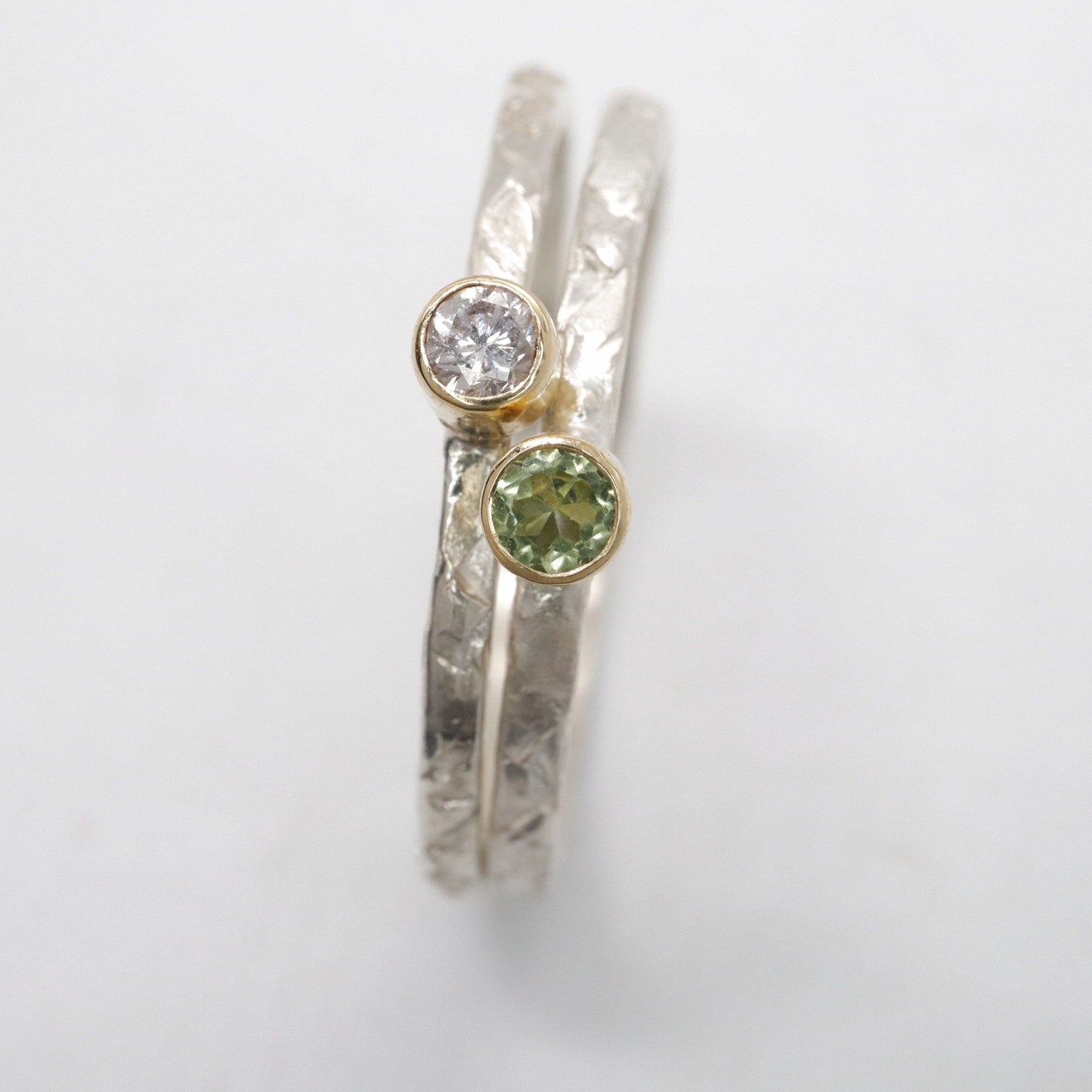 Stacking two ring set with peridot and diamond, Striding Edge design in 18ct yellow gold and silver.