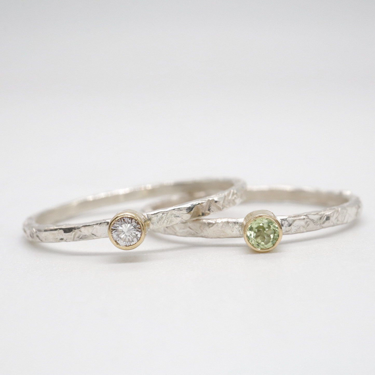 Stacking two ring set with peridot and diamond, Striding Edge design in 18ct yellow gold and silver.