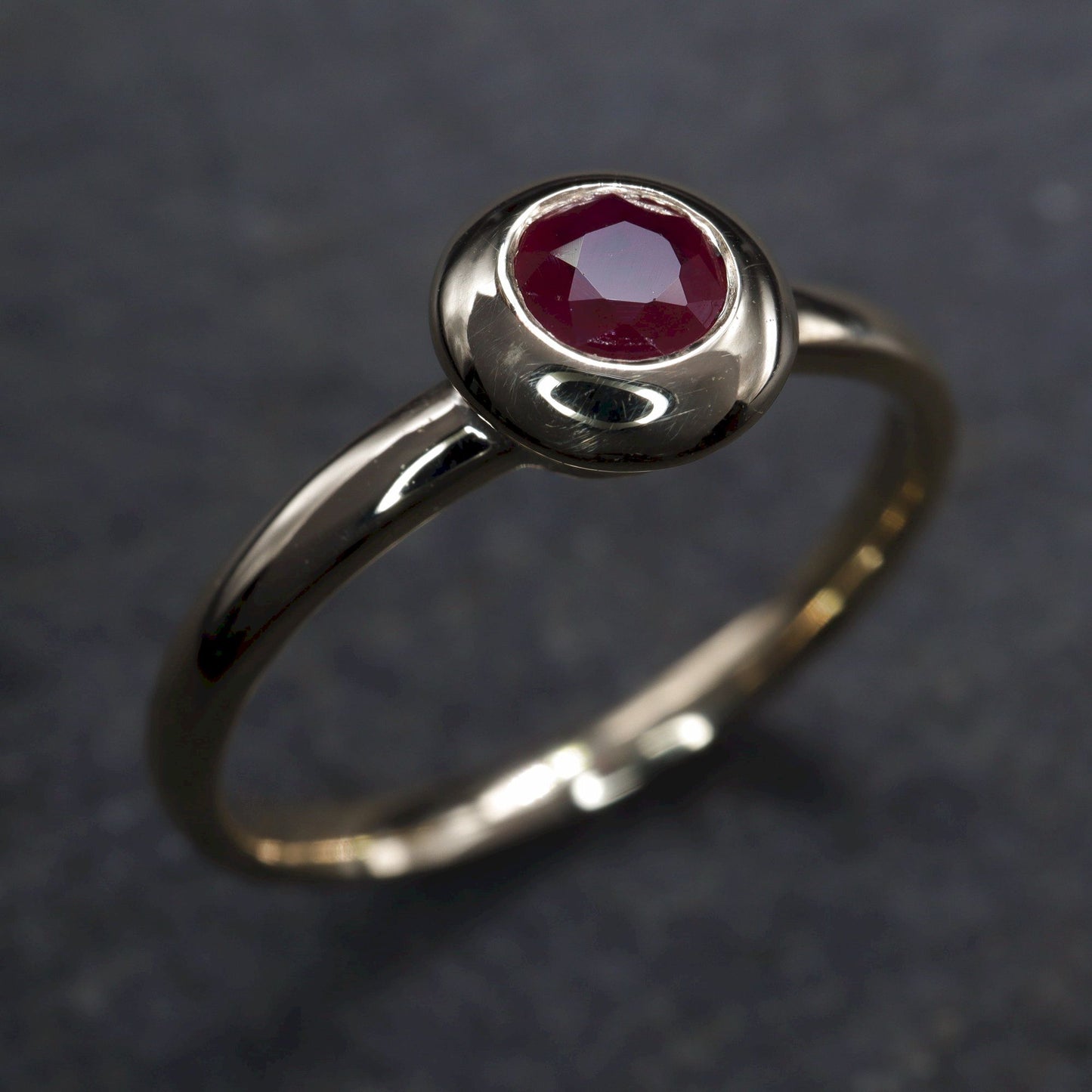 Solitaire fine Ruby engagement ring in yellow gold.