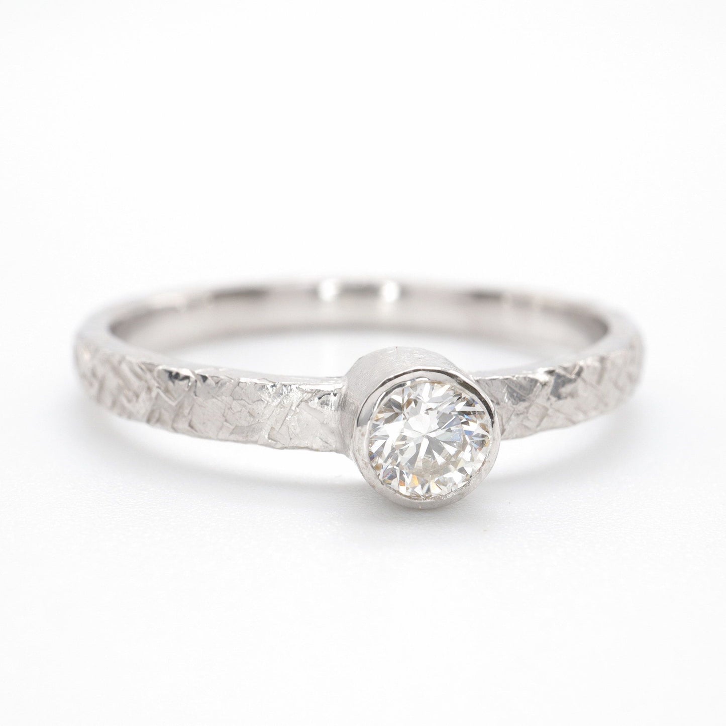 Solitaire quarter carat diamond Fire design white gold ring