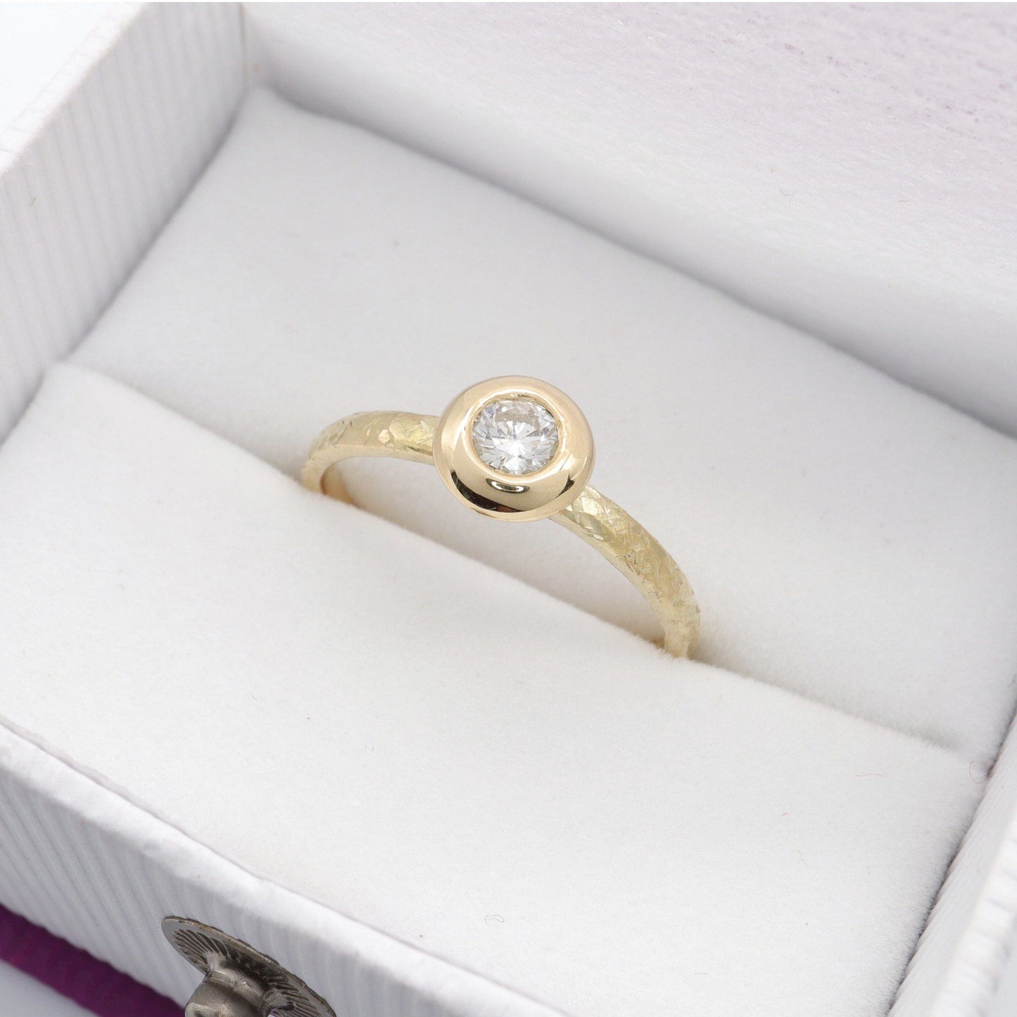 Solitaire diamond ring in 18ct yellow gold with a wide edge setting