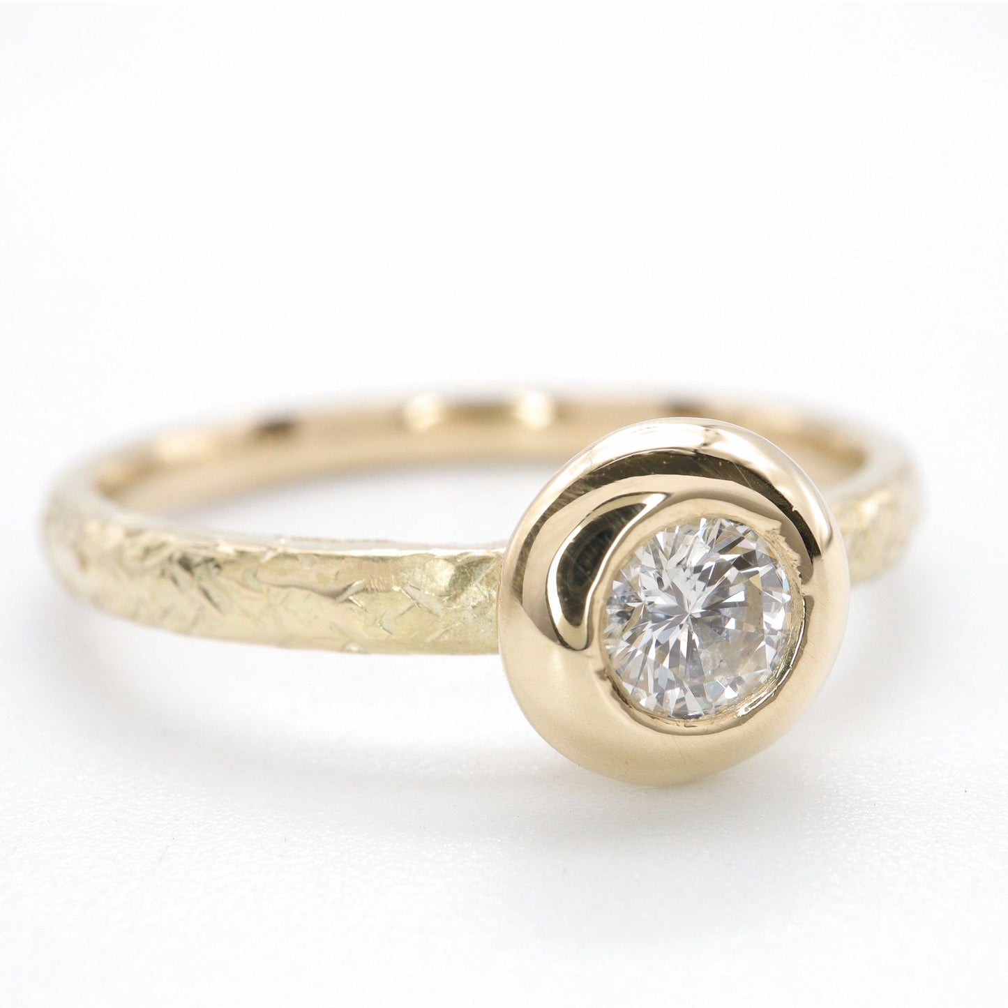 Solitaire diamond ring in 18ct yellow gold with a wide edge setting