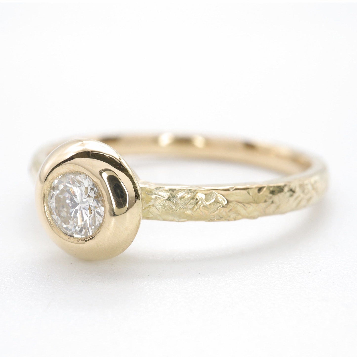 Solitaire diamond ring in 18ct yellow gold with a wide edge setting
