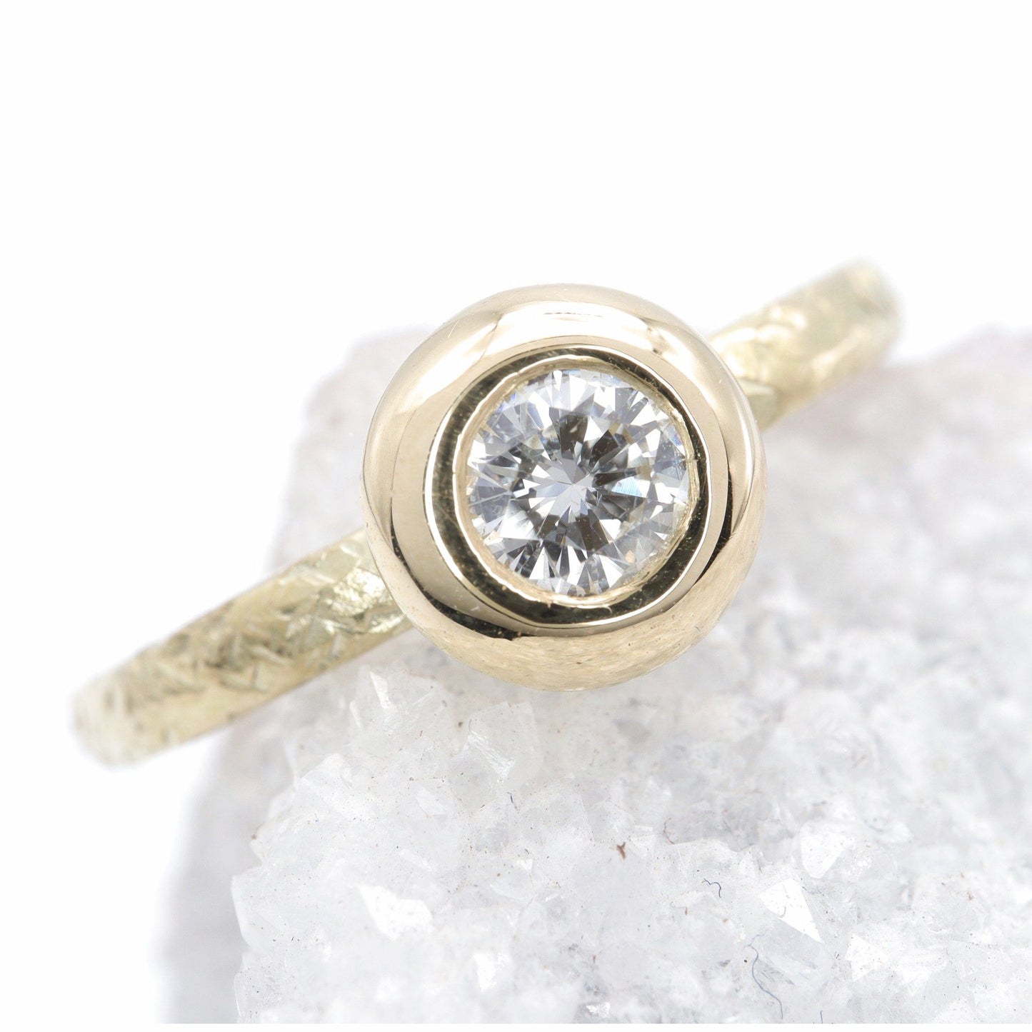 Solitaire diamond ring in 18ct yellow gold with a wide edge setting