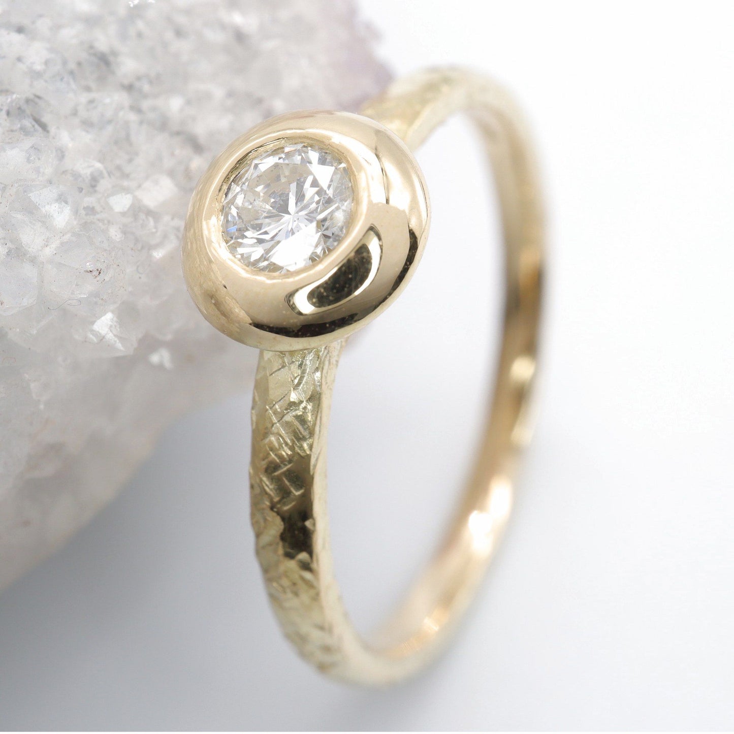 Solitaire diamond ring in 18ct yellow gold with a wide edge setting